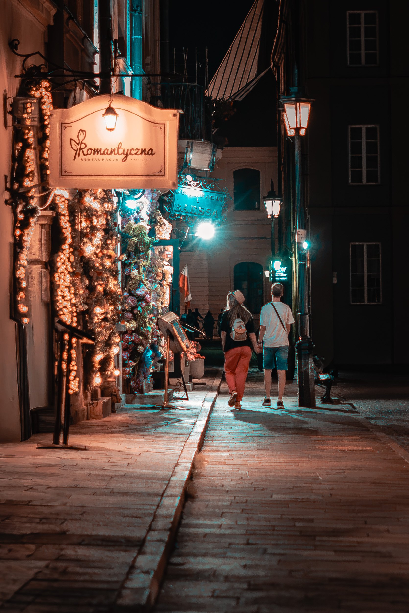 Couple walking hand in hand outside restaurant