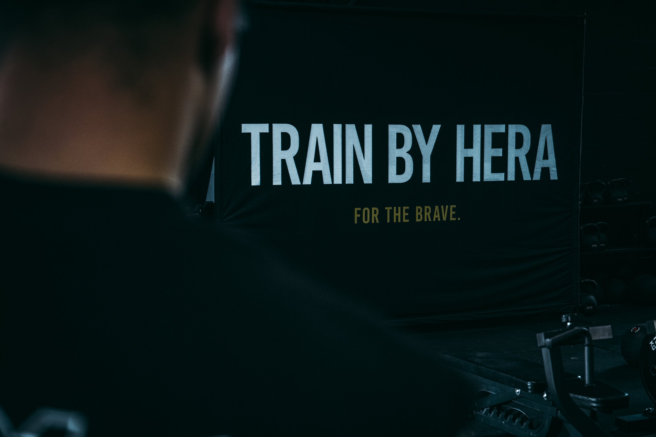 Over shoulder view of Train By HERA sign