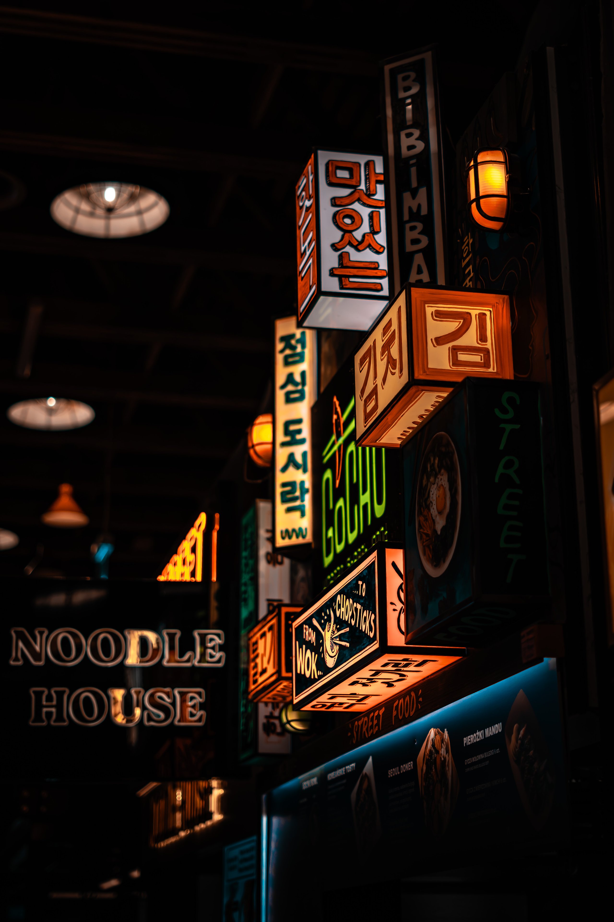 Noodle House at night with neon signs
