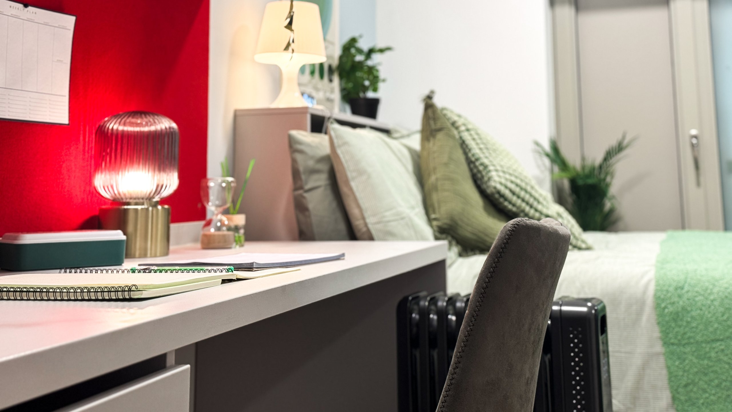 A desk and bed in a studio room